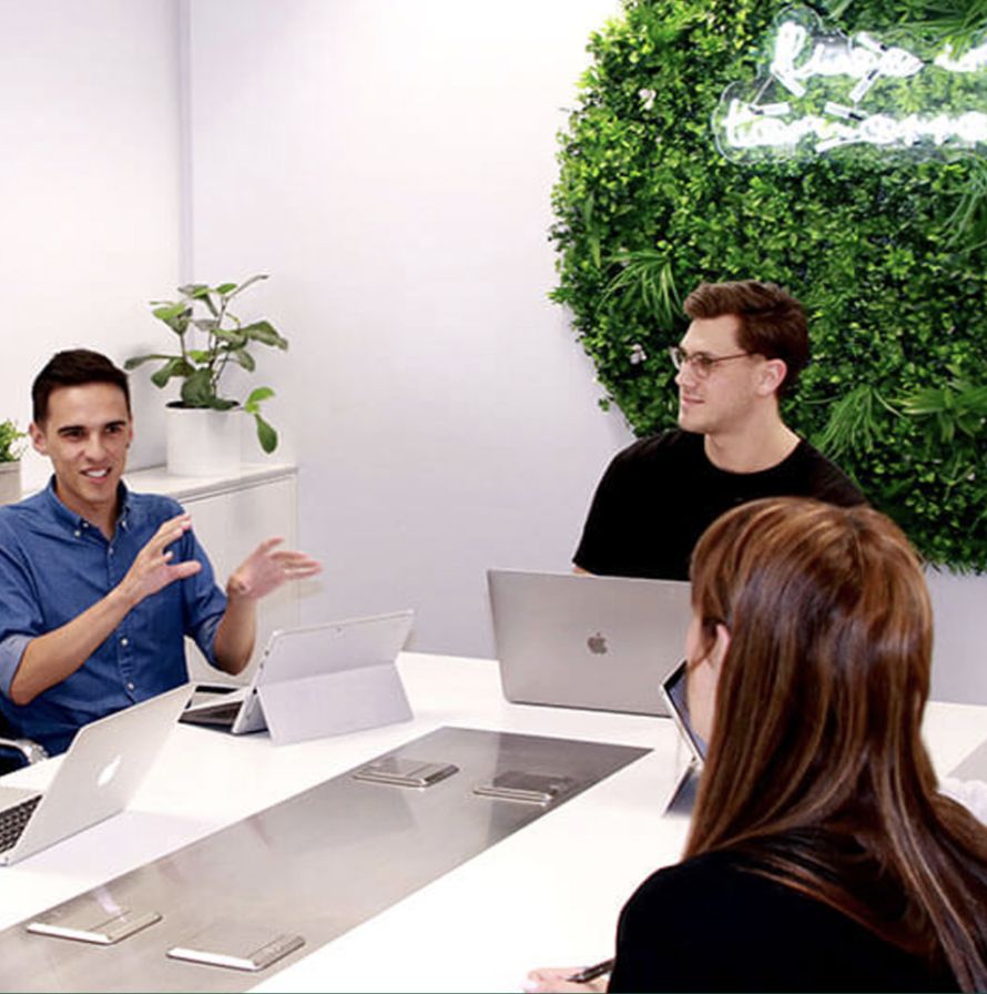 Team of three people collaborating in an office.