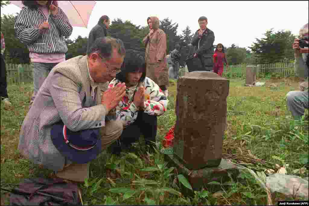 Japanese former residents visiting relatives' graves on Kunashir island. Analysts suggest that "alpha" might include fishing rights for Japan near the two larger islands or the rights for Japanese citizens to visit and do business on the disputed islands. If Russia and Japan can find an "alpha" that is acceptable to both sides, a peace treaty can be signed and World War II might finally, formally end for these two nations.