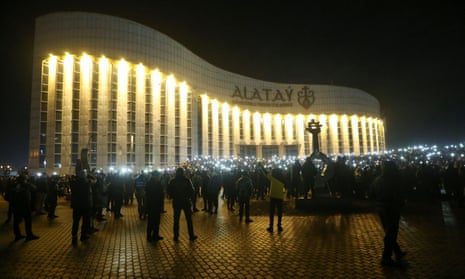 Crowds of protesters light up their phones in central Almaty