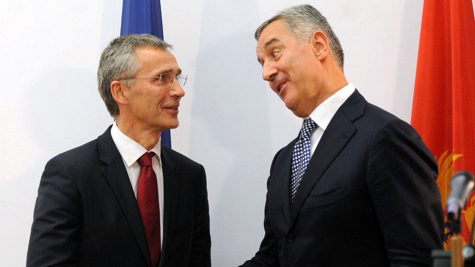 Montenegro's Prime Minister Milo Djukanovic (R) shakes hands with NATO Secretary General Jens Stoltenberg after a joint press conference on October 15, 2015 in Podgorica