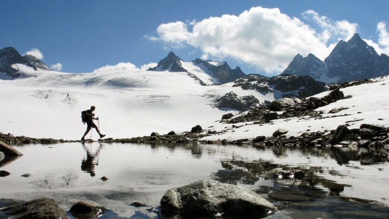 Image: A hiker walks near the Silvretta glacier in the Swiss Alps.