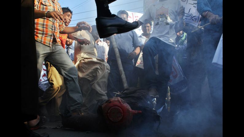 Pakistani demonstrators beat an effigy of Florida pastor Terry Jones during a protest against an anti-Islam film in Lahore on Monday, September 24. More than 50 people have died around the world in violence linked to protests against the low-budget movie, which mocks Islam and the Prophet Mohammed, since the first demonstrations erupted on September 11. <a href=