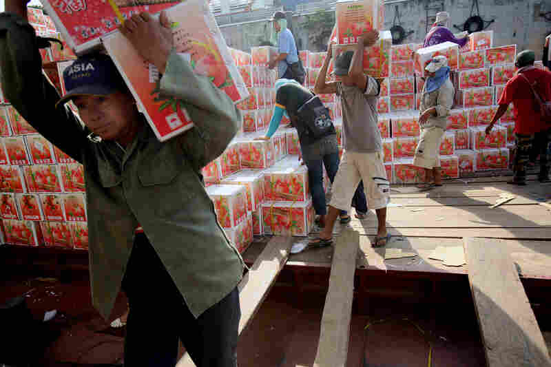 Dock workers unload fruit from a Chinese freighter at Chiang Saen's port on the Mekong River.