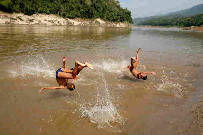 Laotian children jump into the Mekong River north of Luang Prabang, the country's ancient royal capital.