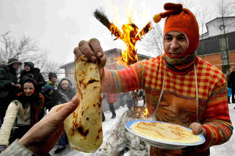 A man dressed as a medieval East Slavic harlequin distributes blini in St. Petersburg, Russia, during the last day of Maslenitsa in 2009. The festival originated in pagan times as a way to mark the end of winter and beginning of spring. Pancakes known as blinis abound: Their round shape and warmth were meant to symbolize the sun.