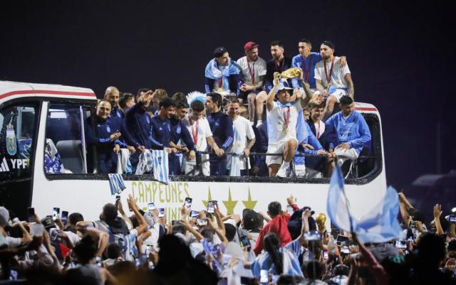 Argentina men’s national football team player Lisandro Martinez holds up the FIFA World Cup as they arrive to the teams headquarters (Getty Images)