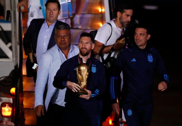 Argentina’s Lionel Messi with the trophy during the team’s arrival at Ezeiza International Airport (REUTERS)