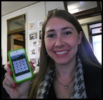 Author Robyn Norgan holding a smartphone